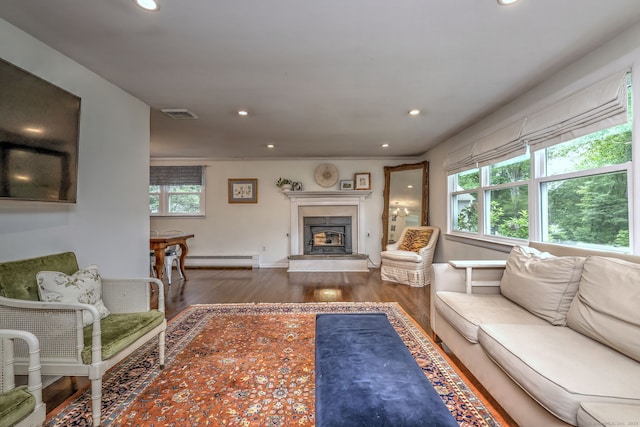 1690 Hartford Tpke, North Haven, CT 06473 - living room featuring wood finished floors, recessed lighting, baseboard heating, a fireplace with raised hearth, and baseboards