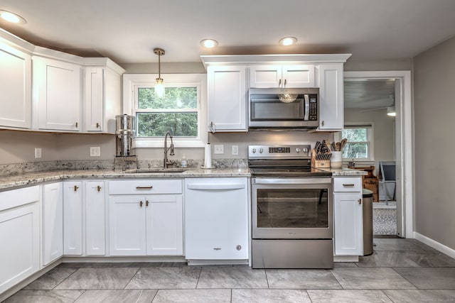 1690 Hartford Tpke, North Haven, CT 06473 - kitchen with appliances with stainless steel finishes, a sink, white cabinetry, and light stone countertops