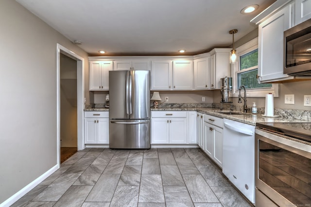 1690 Hartford Tpke, North Haven, CT 06473 - kitchen featuring appliances with stainless steel finishes, a sink, white cabinetry, light stone countertops, and recessed lighting