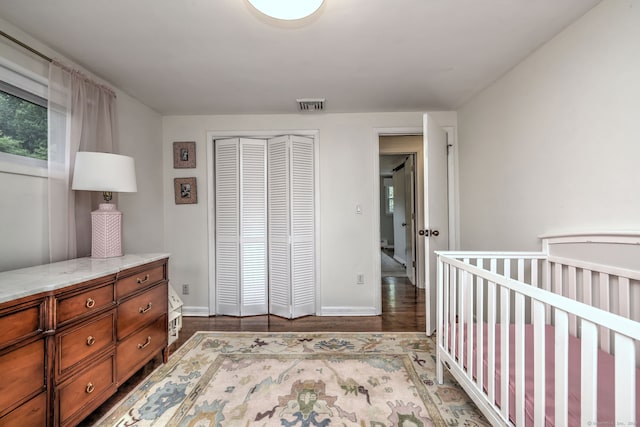 1690 Hartford Tpke, North Haven, CT 06473 - bedroom featuring a closet, wood finished floors, baseboards, and multiple windows