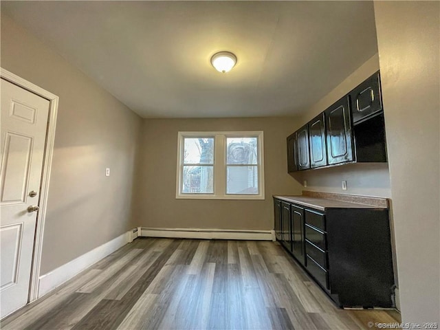 158 Martin St, Hartford, CT 06120 - kitchen with a baseboard heating unit, dark cabinetry, wood finished floors, and baseboards