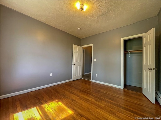 158 Martin St, Hartford, CT 06120 - unfurnished bedroom with wood finished floors, a textured ceiling, baseboards, and a closet