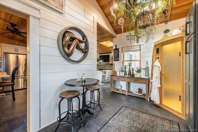 311 Captain Thomas Blvd, West Haven, CT 06516 - kitchen with high end fridge, wood ceiling, wooden walls, lofted ceiling, and a ceiling fan