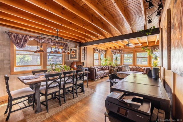 311 Captain Thomas Blvd, West Haven, CT 06516 - dining space with healthy amount of natural light, wood finished floors, and wooden ceiling with exposed beams