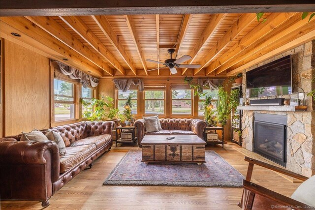 311 Captain Thomas Blvd, West Haven, CT 06516 - living room with a ceiling fan, a stone fireplace, wood finished floors, and wood ceiling