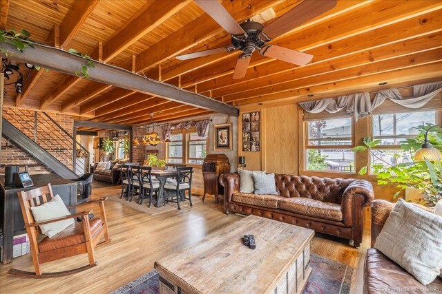 311 Captain Thomas Blvd, West Haven, CT 06516 - living room with healthy amount of natural light, wood finished floors, a ceiling fan, stairway, and wood ceiling