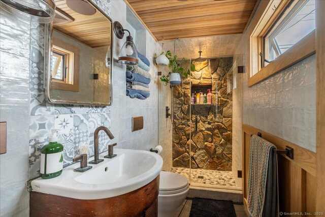 311 Captain Thomas Blvd, West Haven, CT 06516 - bathroom with wood ceiling, tile walls, vanity, a shower stall, and toilet