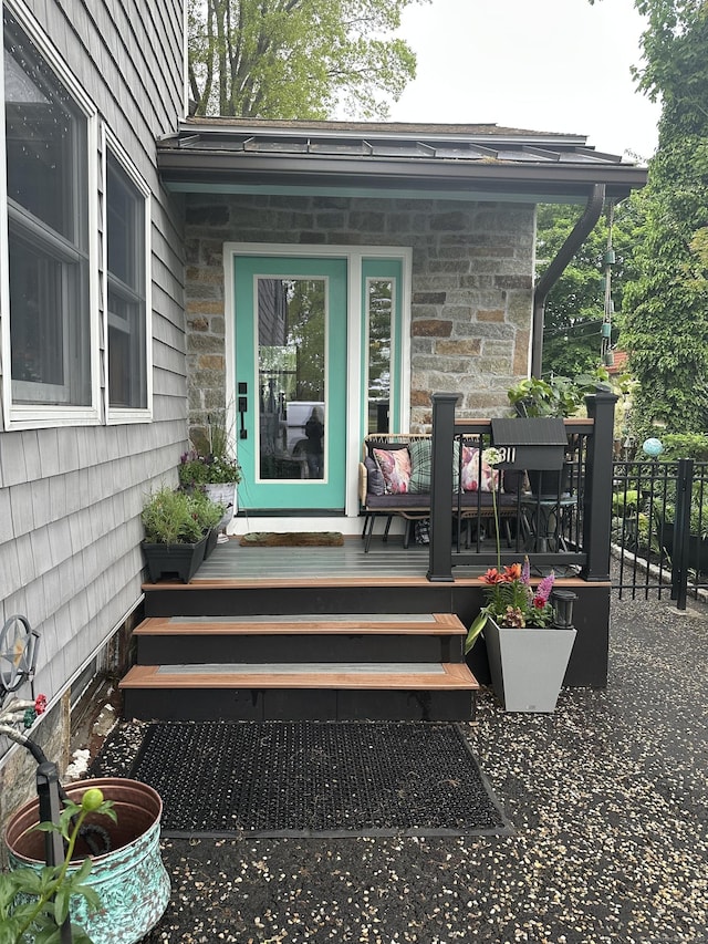 311 Captain Thomas Blvd, West Haven, CT 06516 - doorway to property featuring stone siding and a wooden deck