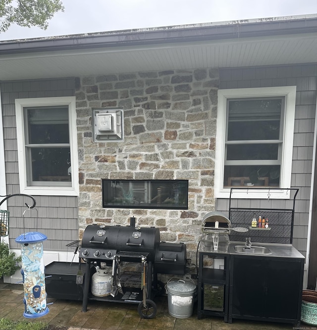 311 Captain Thomas Blvd, West Haven, CT 06516 - view of patio / terrace with area for grilling, a sink, and a fireplace