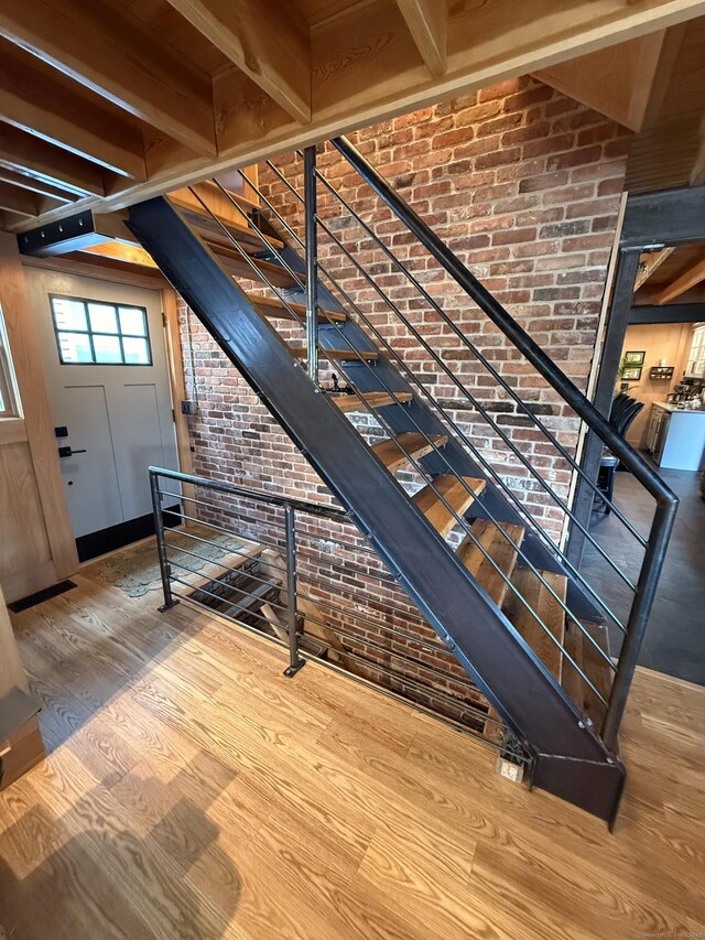 311 Captain Thomas Blvd, West Haven, CT 06516 - staircase featuring wood finished floors and brick wall