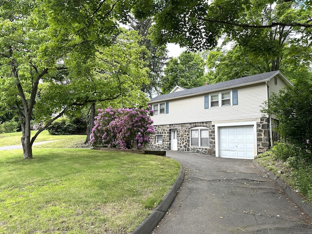 1188 Worthington Rdg, Berlin, CT 06037 - view of front facade with stone siding, a front lawn, driveway, and an attached garage