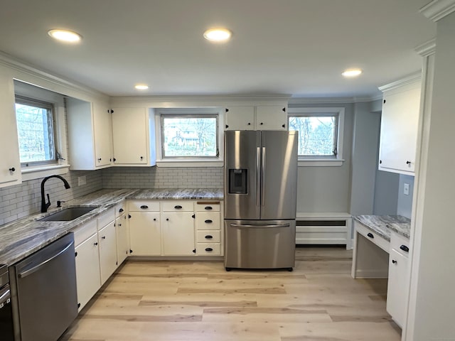1188 Worthington Rdg, Berlin, CT 06037 - kitchen with stainless steel appliances, a sink, decorative backsplash, white cabinetry, and crown molding