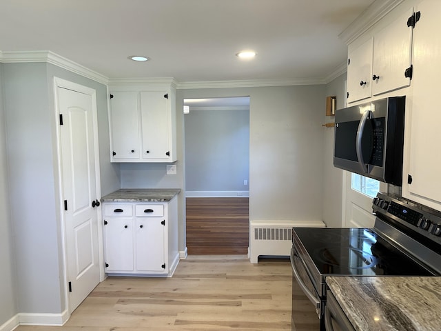 1188 Worthington Rdg, Berlin, CT 06037 - kitchen featuring appliances with stainless steel finishes, light wood-type flooring, radiator, light stone counters, and white cabinets