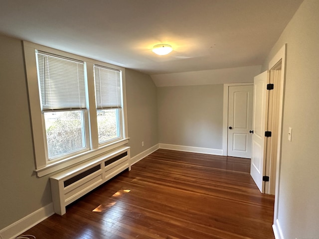 1188 Worthington Rdg, Berlin, CT 06037 - spare room featuring dark wood-type flooring, baseboards, vaulted ceiling, and radiator