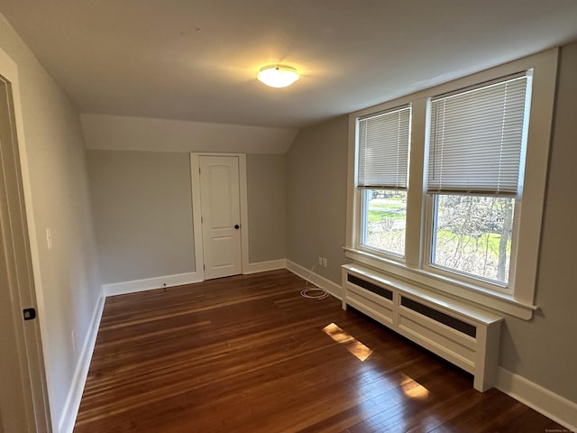 1188 Worthington Rdg, Berlin, CT 06037 - spare room featuring dark wood-style floors, vaulted ceiling, baseboards, and radiator