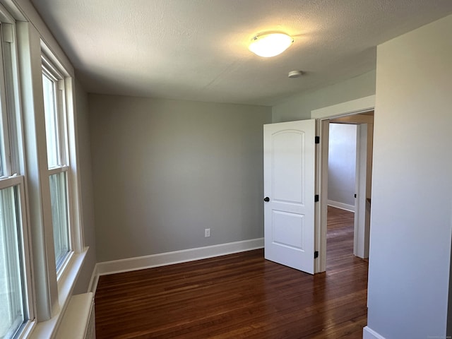 1188 Worthington Rdg, Berlin, CT 06037 - spare room with dark wood finished floors, healthy amount of natural light, baseboards, a smoke detector, and a textured ceiling