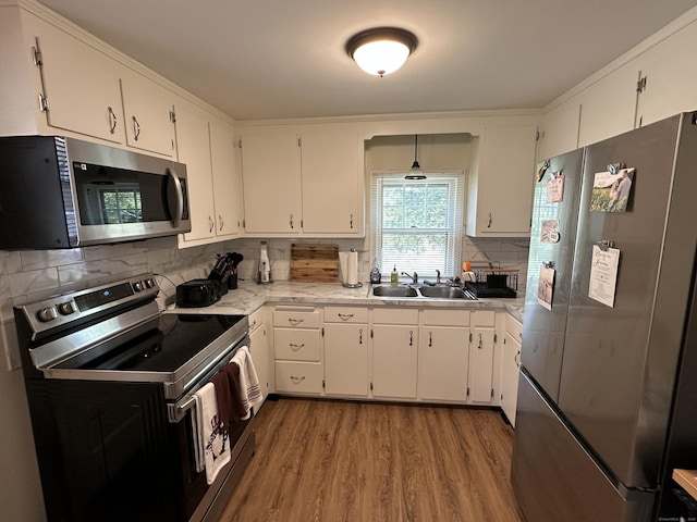 1188 Worthington Rdg, Berlin, CT 06037 - kitchen with appliances with stainless steel finishes, a sink, wood finished floors, light countertops, and white cabinetry