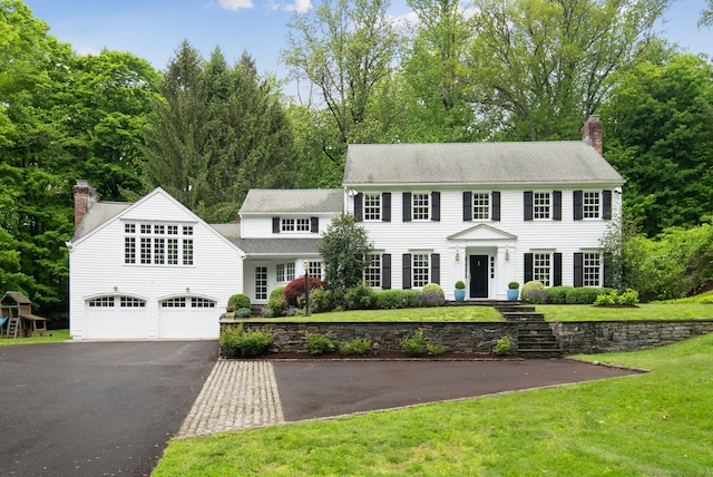 104 Cheesespring Rd, Wilton, CT 06897 - colonial-style house with driveway, a chimney, a front yard, and a shingled roof