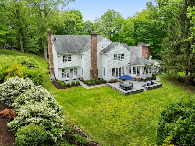 104 Cheesespring Rd, Wilton, CT 06897 - back of property featuring french doors, a patio area, a chimney, and a yard