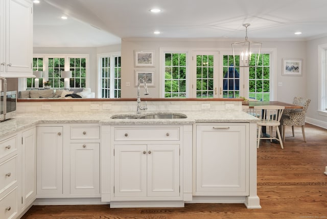 104 Cheesespring Rd, Wilton, CT 06897 - kitchen featuring a sink, white cabinetry, plenty of natural light, light stone countertops, and ornamental molding
