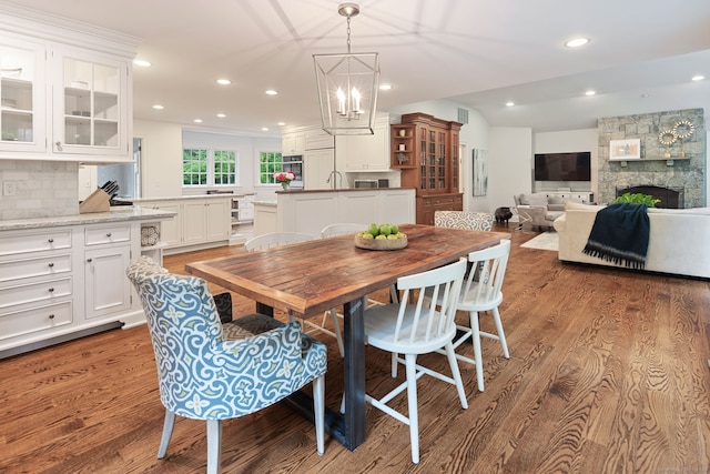 104 Cheesespring Rd, Wilton, CT 06897 - dining area featuring wood finished floors, a fireplace, a chandelier, and recessed lighting