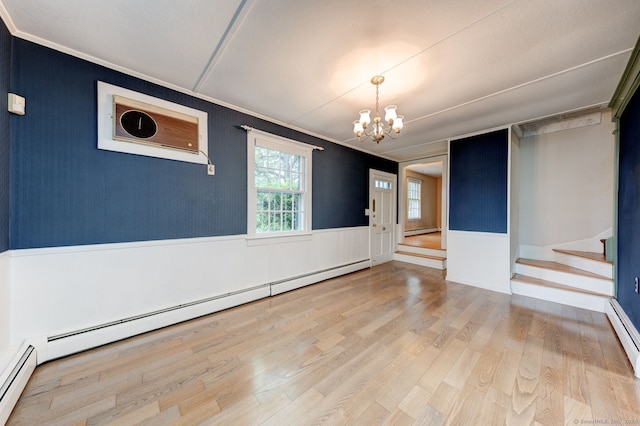 216 Belleview Ave, Southington, CT 06489 - unfurnished room with a chandelier, wood finished floors, crown molding, wainscoting, and a baseboard heating unit