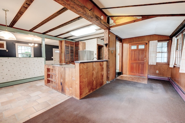 216 Belleview Ave, Southington, CT 06489 - kitchen with freestanding refrigerator, lofted ceiling, a chandelier, wooden walls, and pendant lighting