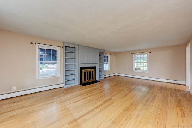 216 Belleview Ave, Southington, CT 06489 - unfurnished living room featuring hardwood / wood-style flooring, a baseboard radiator, and a fireplace with flush hearth