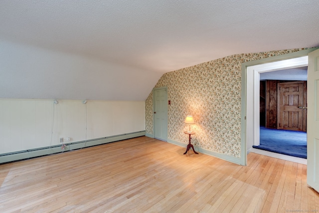 216 Belleview Ave, Southington, CT 06489 - bonus room with hardwood / wood-style flooring, lofted ceiling, a baseboard heating unit, and baseboards