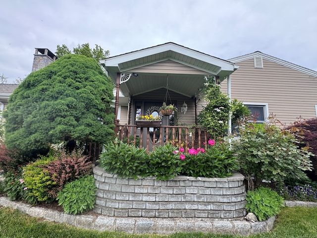 91 Lounsbury Rd, Trumbull, CT 06611 - rear view of house featuring a chimney and a porch