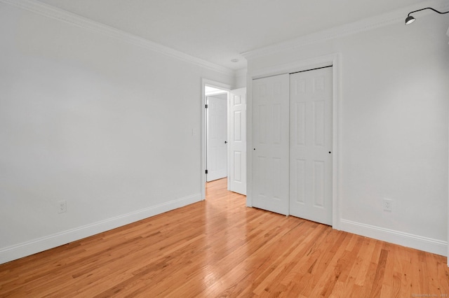 71 Mountain Laurel Dr Unit 71, Wethersfield, CT 06109 - unfurnished bedroom with crown molding, baseboards, light wood-type flooring, and a closet