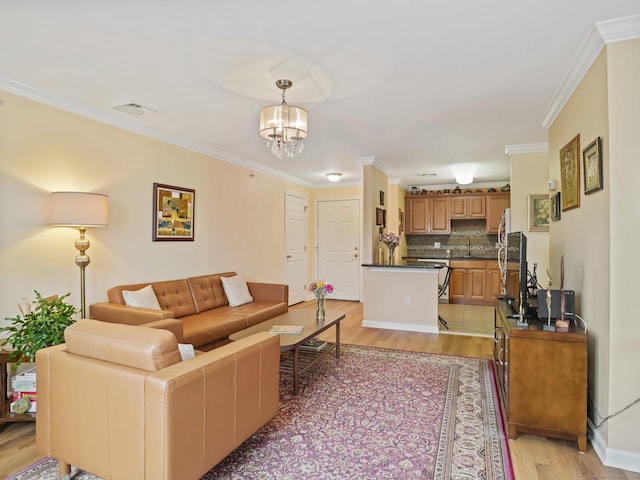 19 Isaacs St Apt 307, Norwalk, CT 06850 - living area with light wood-style floors, ornamental molding, and a chandelier