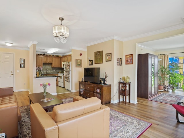19 Isaacs St Apt 307, Norwalk, CT 06850 - living area with light wood-style flooring, baseboards, a chandelier, and ornamental molding