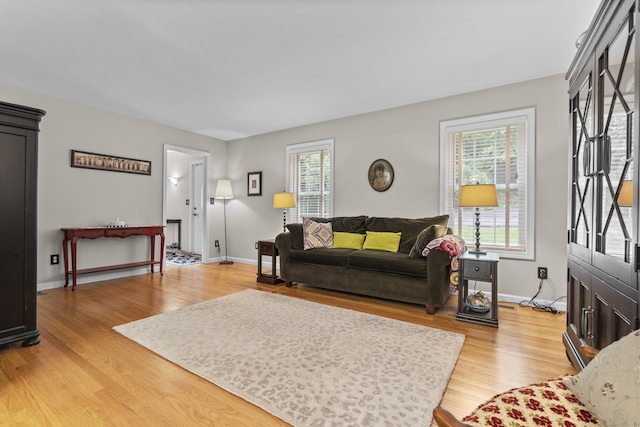12 Colonial Heights Rd, East Haven, CT 06473 - living room with plenty of natural light, light wood-style floors, and baseboards