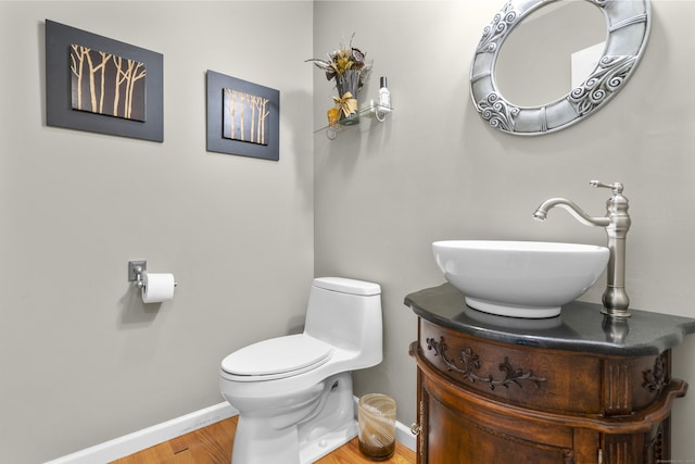 12 Colonial Heights Rd, East Haven, CT 06473 - half bathroom with baseboards, wood finished floors, toilet, and vanity