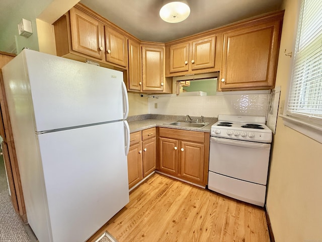 14 Arrowhead Way Apt C1, Woodbury, CT 06798 - kitchen with white appliances, a sink, light wood-style flooring, decorative backsplash, and light countertops
