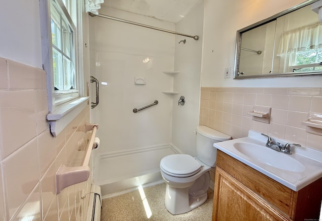 14 Arrowhead Way Apt C1, Woodbury, CT 06798 - bathroom with baseboard heating, tile walls, toilet, a shower, and vanity