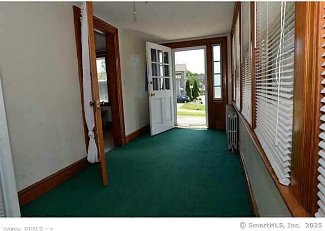 33 Silver St, Branford, CT 06405 - doorway featuring baseboards, radiator, and carpet
