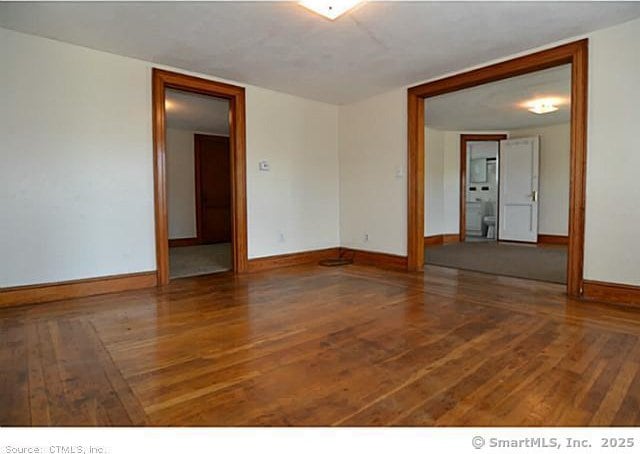 33 Silver St, Branford, CT 06405 - unfurnished room featuring wood finished floors and baseboards