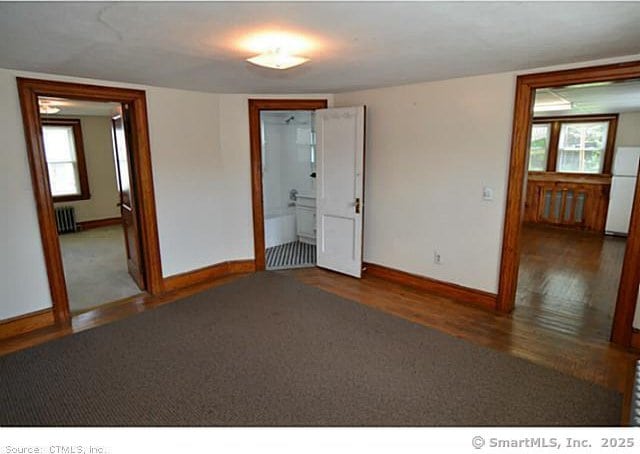 33 Silver St, Branford, CT 06405 - unfurnished room featuring wood finished floors, baseboards, and radiator