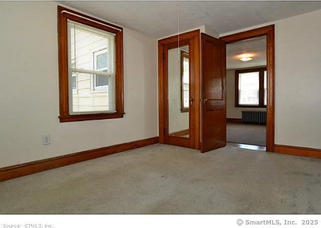 33 Silver St, Branford, CT 06405 - spare room featuring radiator, carpet flooring, and baseboards