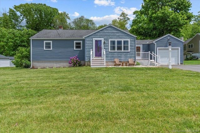 22 Pioneer Dr, North Branford, CT 06471 - single story home featuring entry steps, a garage, asphalt driveway, and a front yard