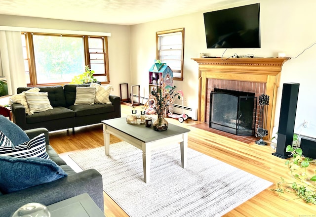 27 Eton Pl, New Britain, CT 06053 - living room featuring a baseboard radiator, wood finished floors, a fireplace, and baseboard heating