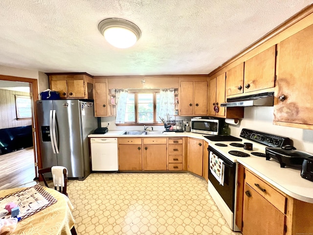 27 Eton Pl, New Britain, CT 06053 - kitchen featuring stainless steel appliances, under cabinet range hood, a sink, light countertops, and healthy amount of natural light