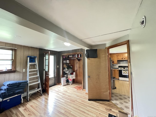 27 Eton Pl, New Britain, CT 06053 - interior space with white electric stove, healthy amount of natural light, light wood finished floors, extractor fan, and wooden walls
