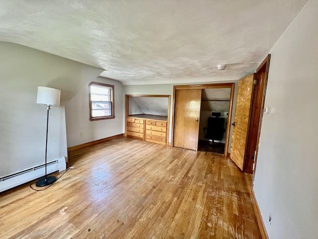 27 Eton Pl, New Britain, CT 06053 - additional living space featuring baseboards, hardwood / wood-style floors, an office area, lofted ceiling, and a textured ceiling