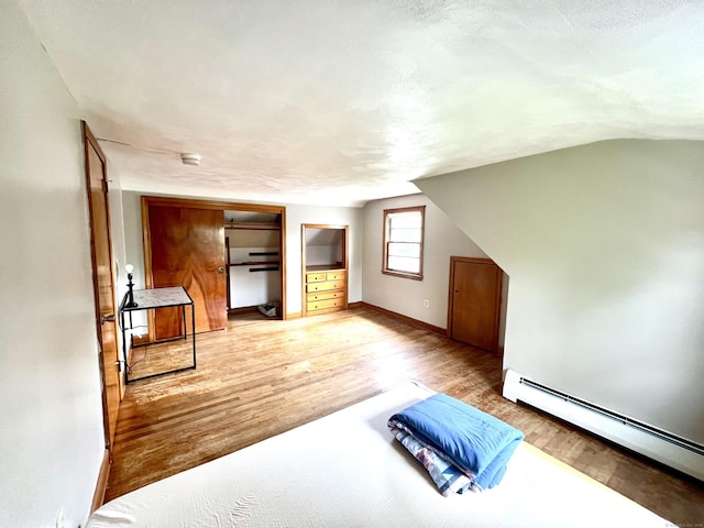 27 Eton Pl, New Britain, CT 06053 - additional living space featuring a baseboard heating unit, light wood-style floors, lofted ceiling, and baseboards