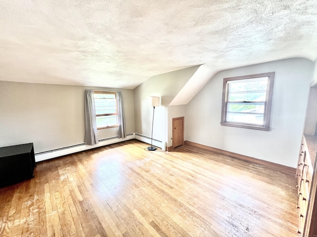 27 Eton Pl, New Britain, CT 06053 - additional living space with wood-type flooring, lofted ceiling, a textured ceiling, baseboard heating, and baseboards