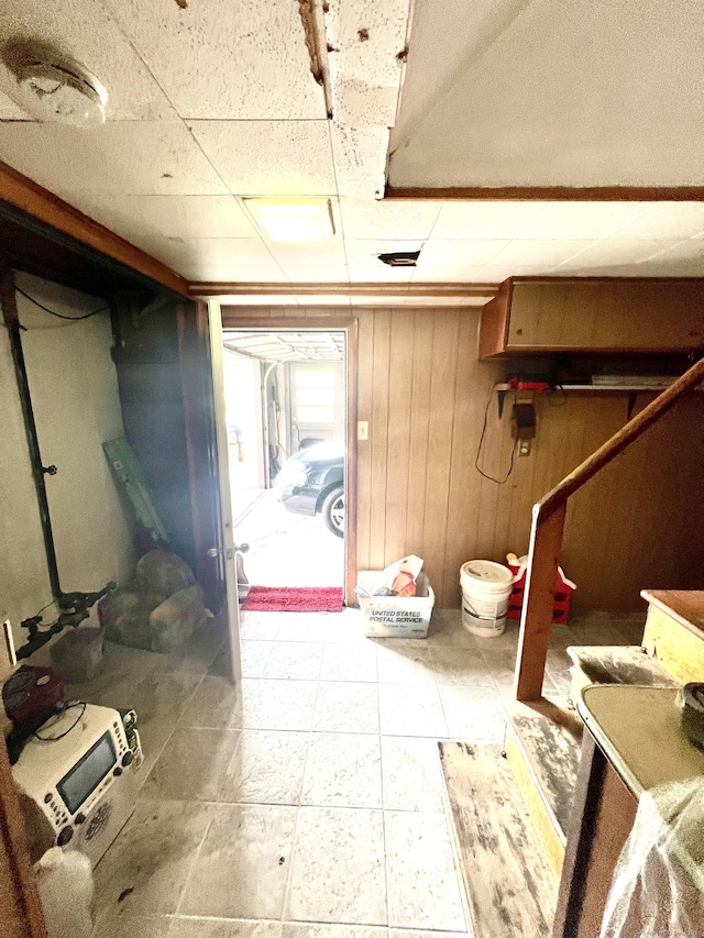 27 Eton Pl, New Britain, CT 06053 - below grade area featuring a drop ceiling and wood walls