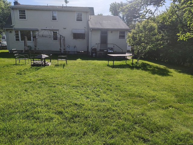 27 Eton Pl, New Britain, CT 06053 - back of property featuring a yard, a chimney, a trampoline, and a gazebo